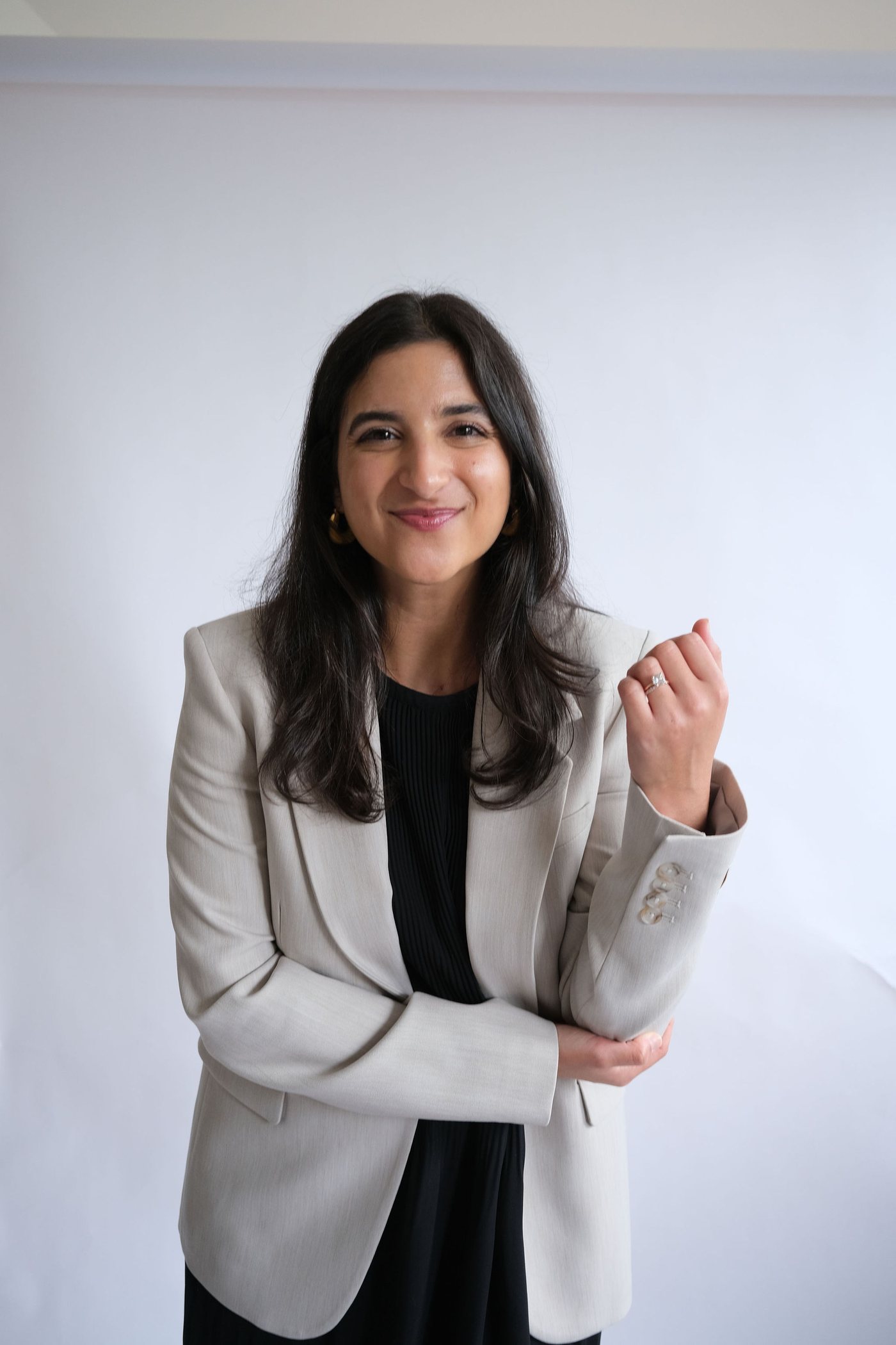 Portrait of Emily Bajalia in a light blazer, smiling